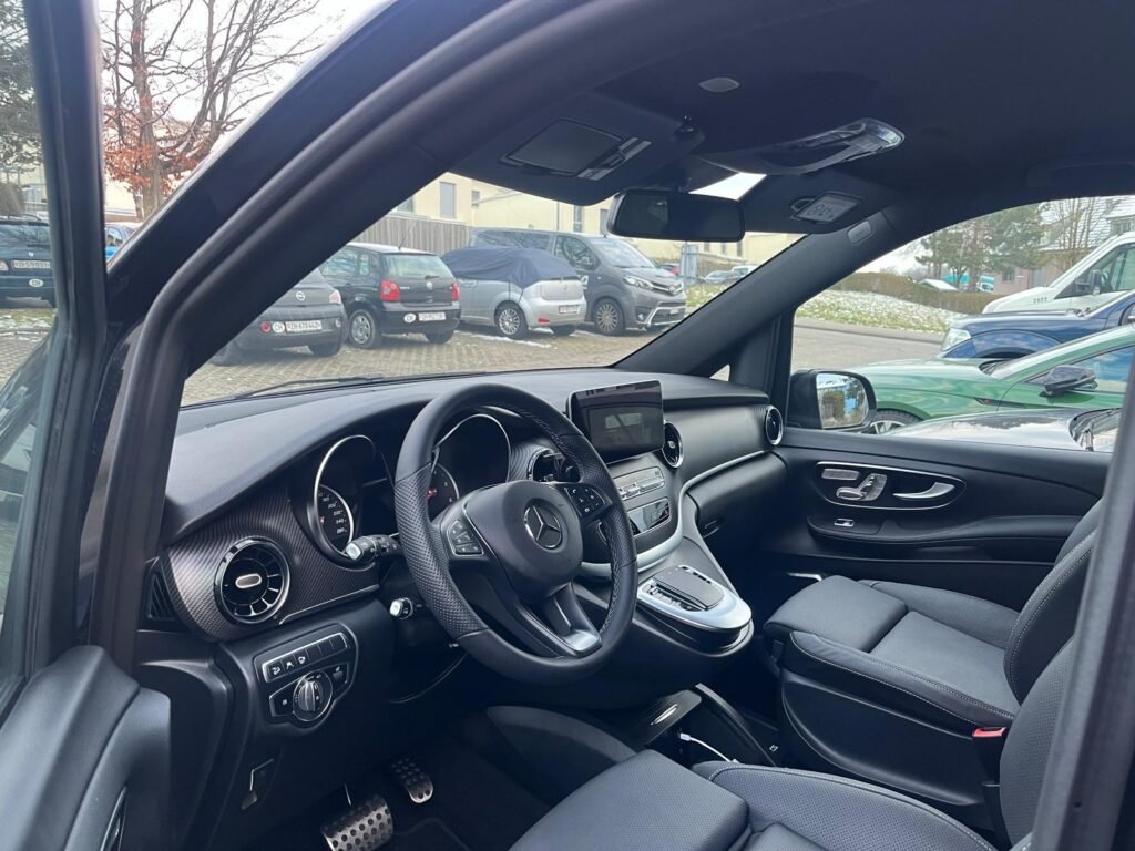 Professional chauffeur providing taxi Amsterdam to Schiphol service with a luxury Mercedes-Benz sedan