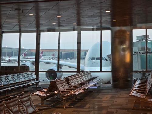 Luxury airport transfer Amsterdam Schiphol chauffeur welcoming international travelers at arrivals terminal
